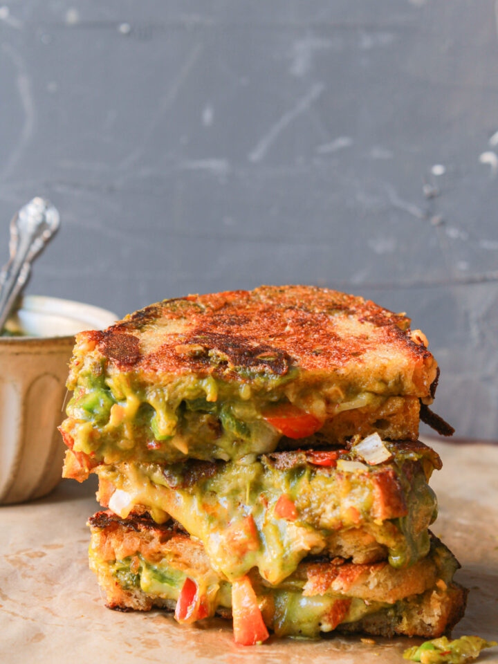 Chutney grilled cheese sandwich with melted mozzarella, cheddar, green chutney, and vegetables