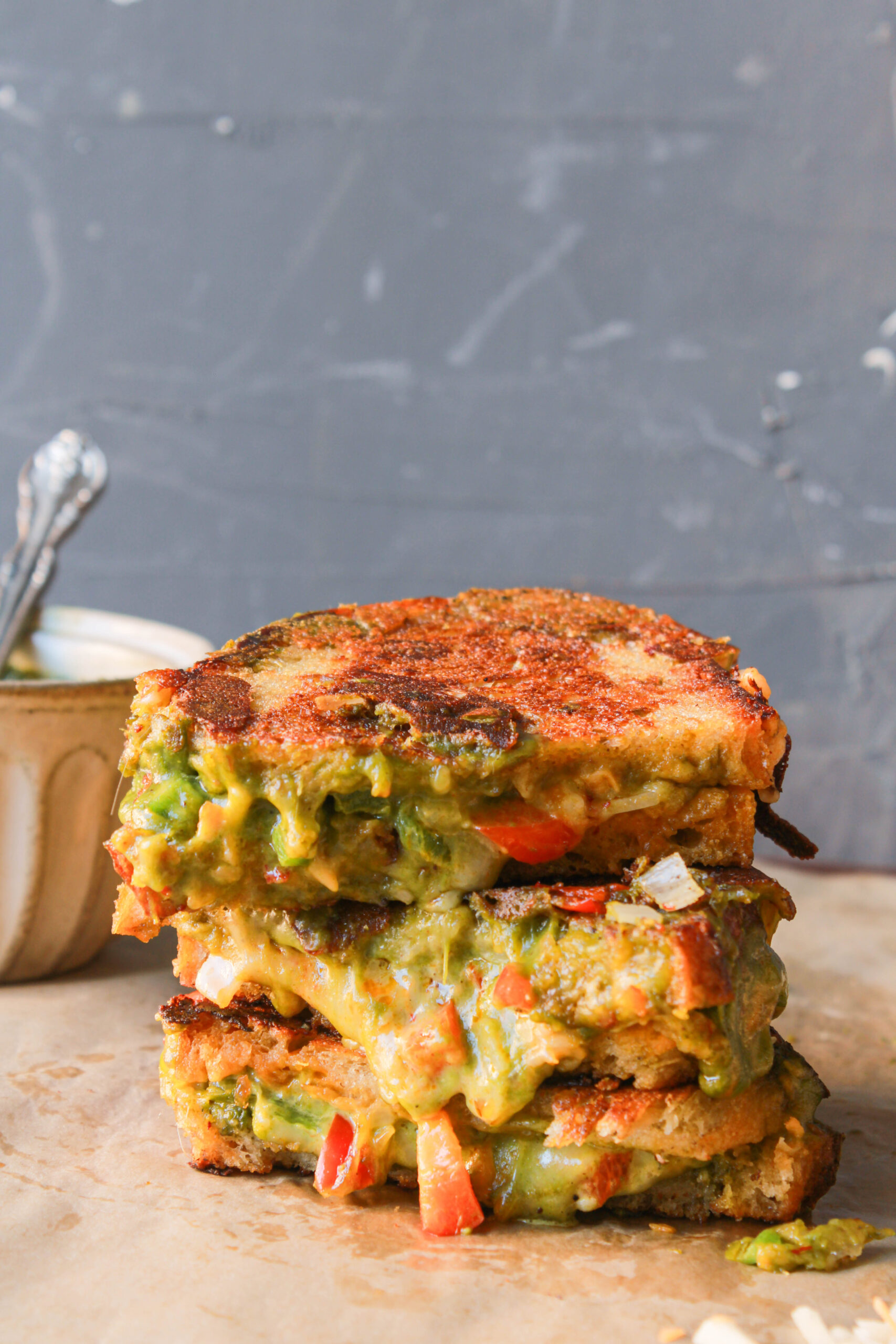 Chutney grilled cheese sandwich with melted mozzarella, cheddar, green chutney, and vegetables